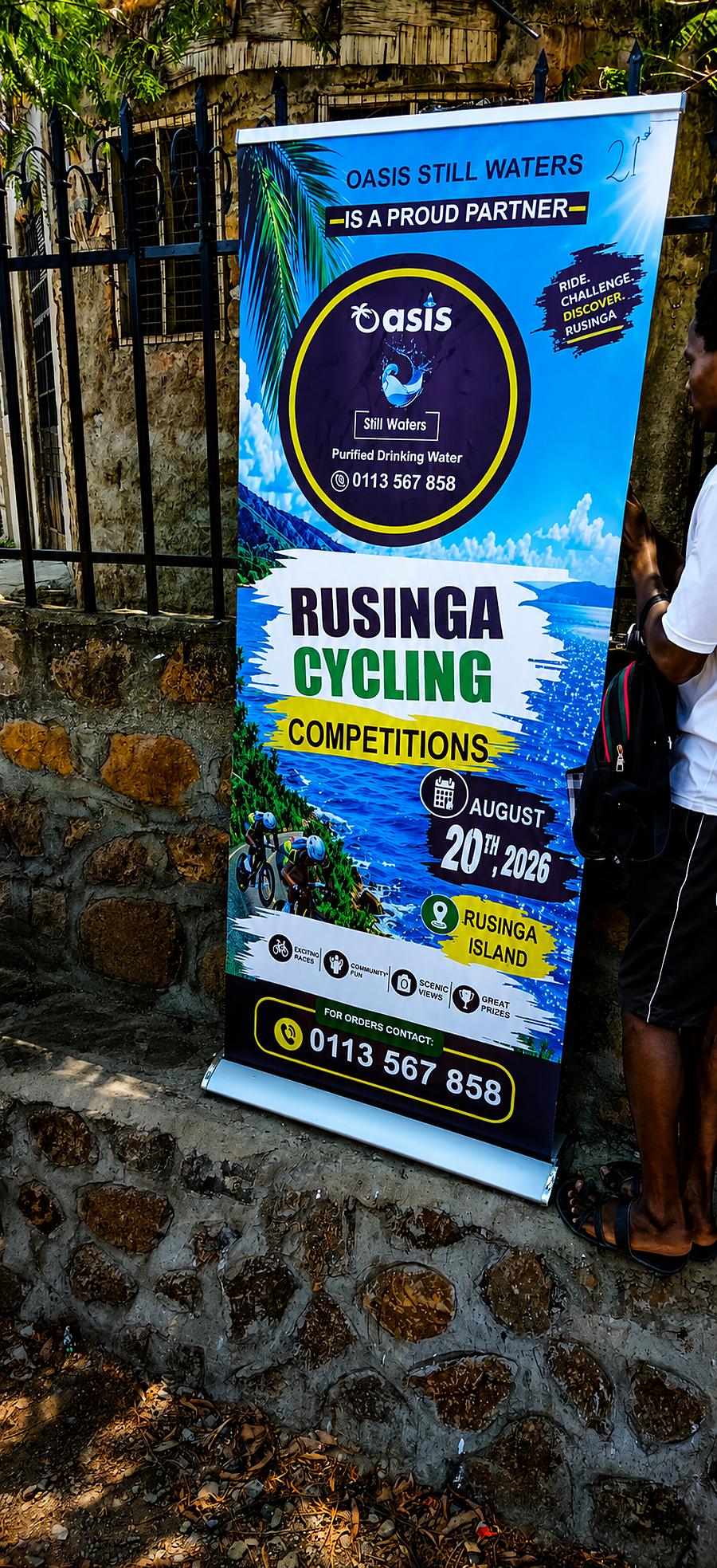 The Oasis Still Waters partner banner for the Rusinga Cycling Competition, displayed at the event entrance