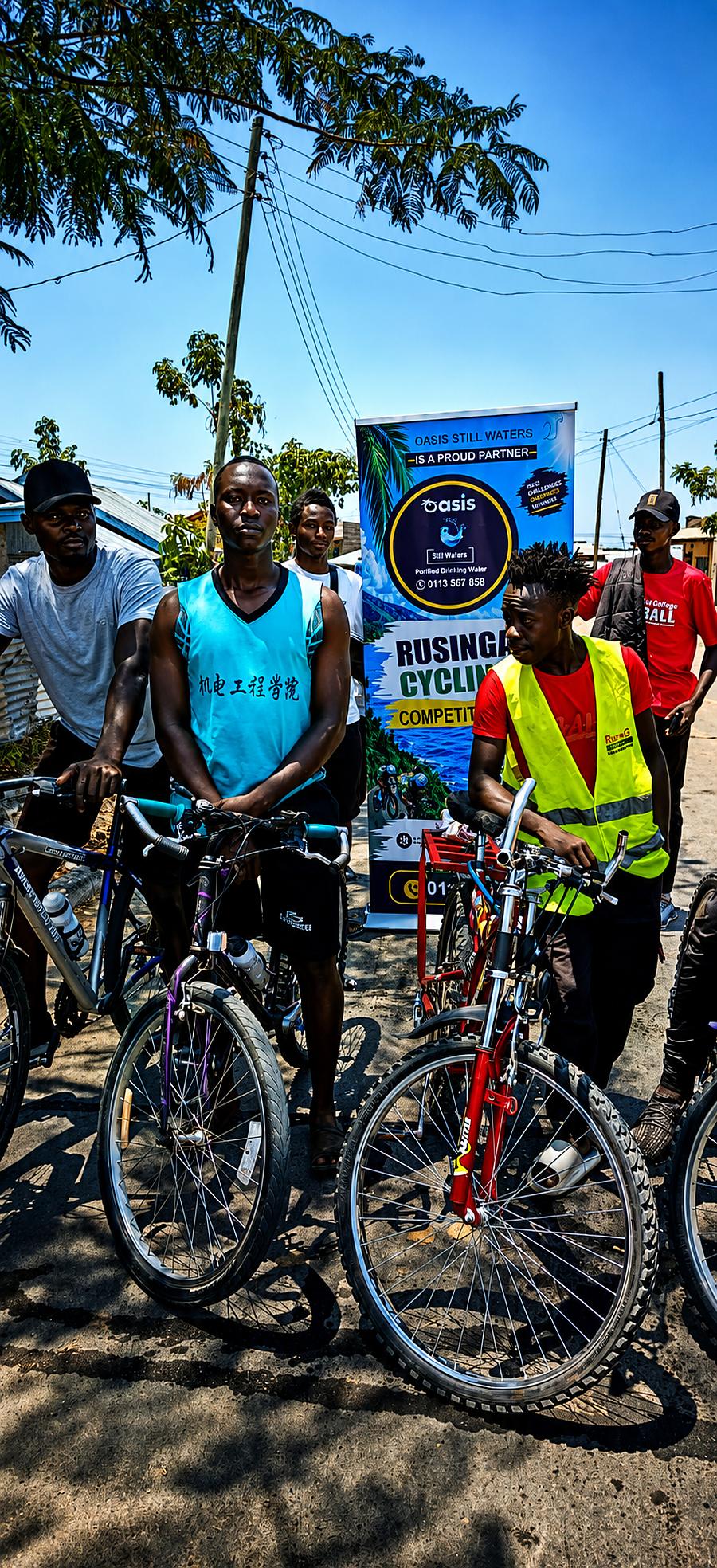 Riders and their bikes lined up next to the Oasis Still Waters Rusinga Cycling banner
